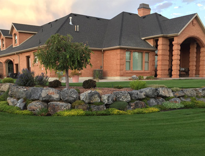 Brick House With Beautiful Landscaping Wrapped Around Front