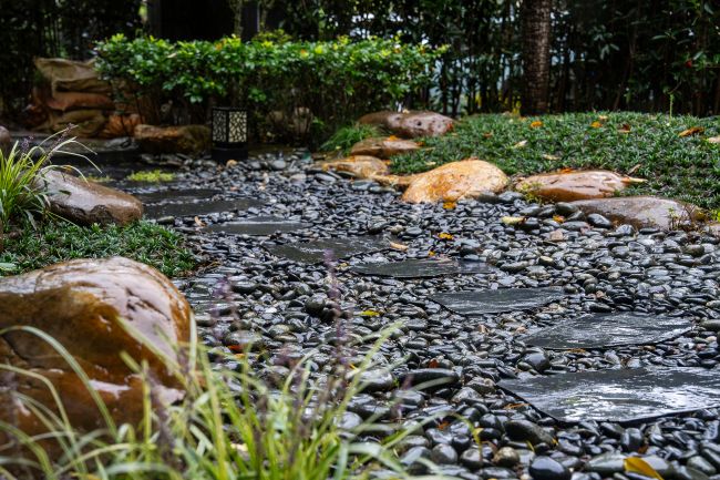 A modern rock landscaping with a natural stone pathway by Sandees Soil and Rock in Utah